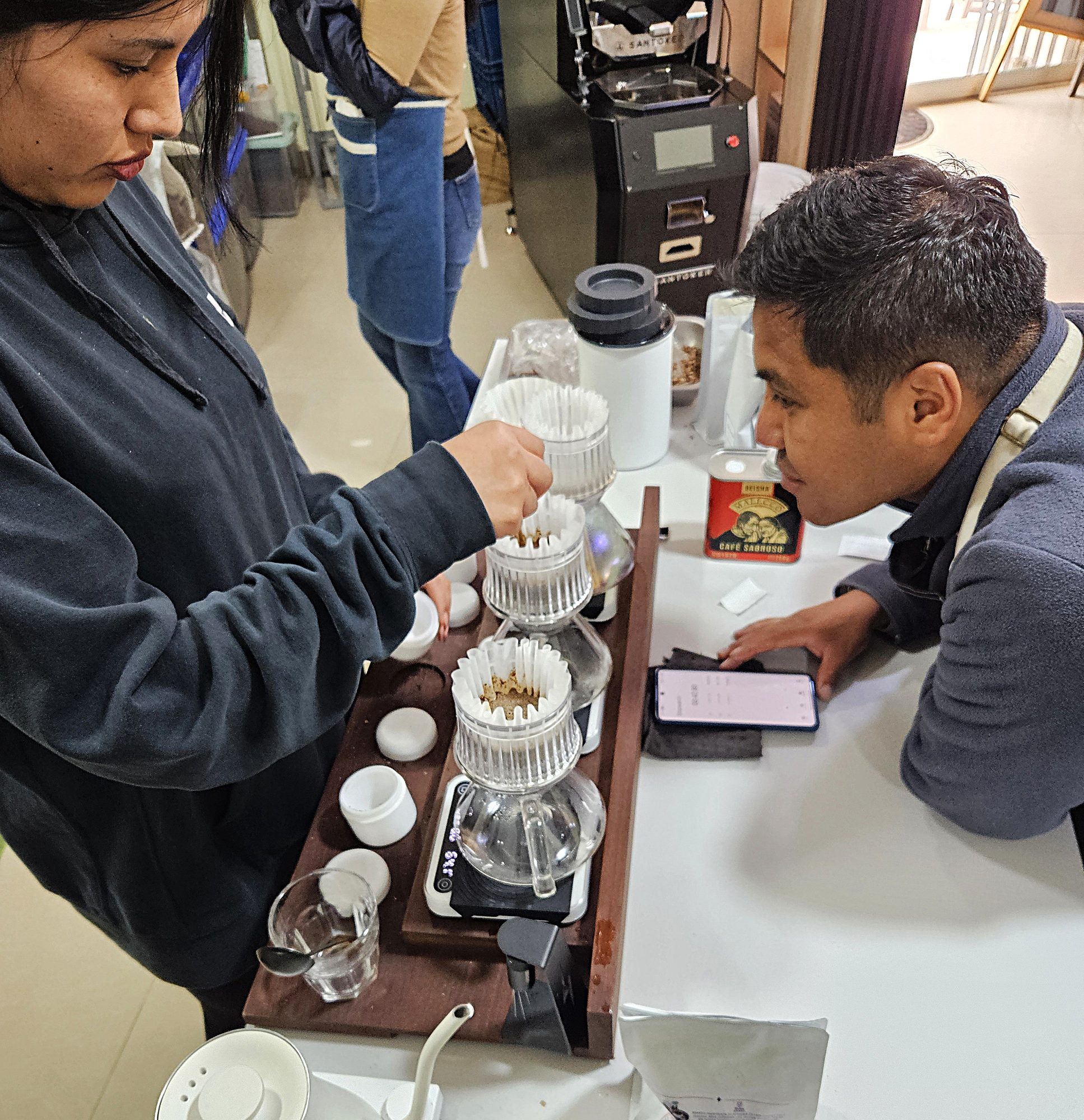 Guests seated along the brew bar in the Cusco coffee lab